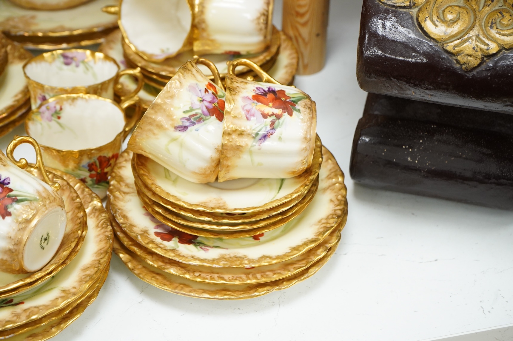 A ‘Nautilus’ porcelain floral and gilt decorated tea service, sandwich plates 23cm diameter.